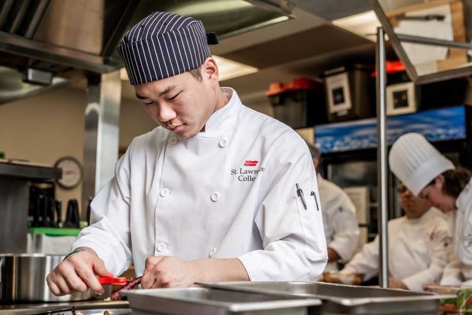 A culinary student works in the kitchen lab.